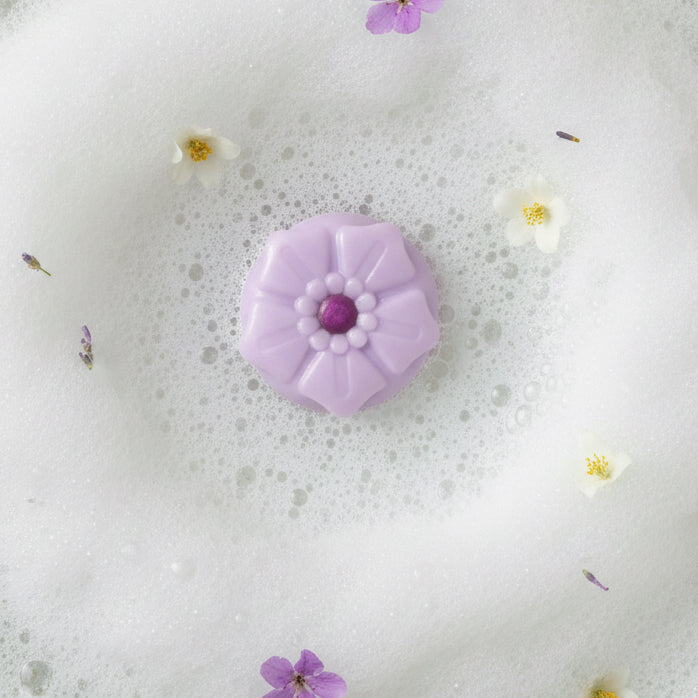 Fig cupcake soap bar in a bubble bath with blossoms