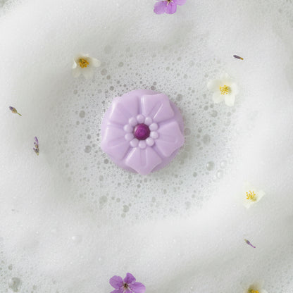 Fig cupcake soap bar in a bubble bath with blossoms